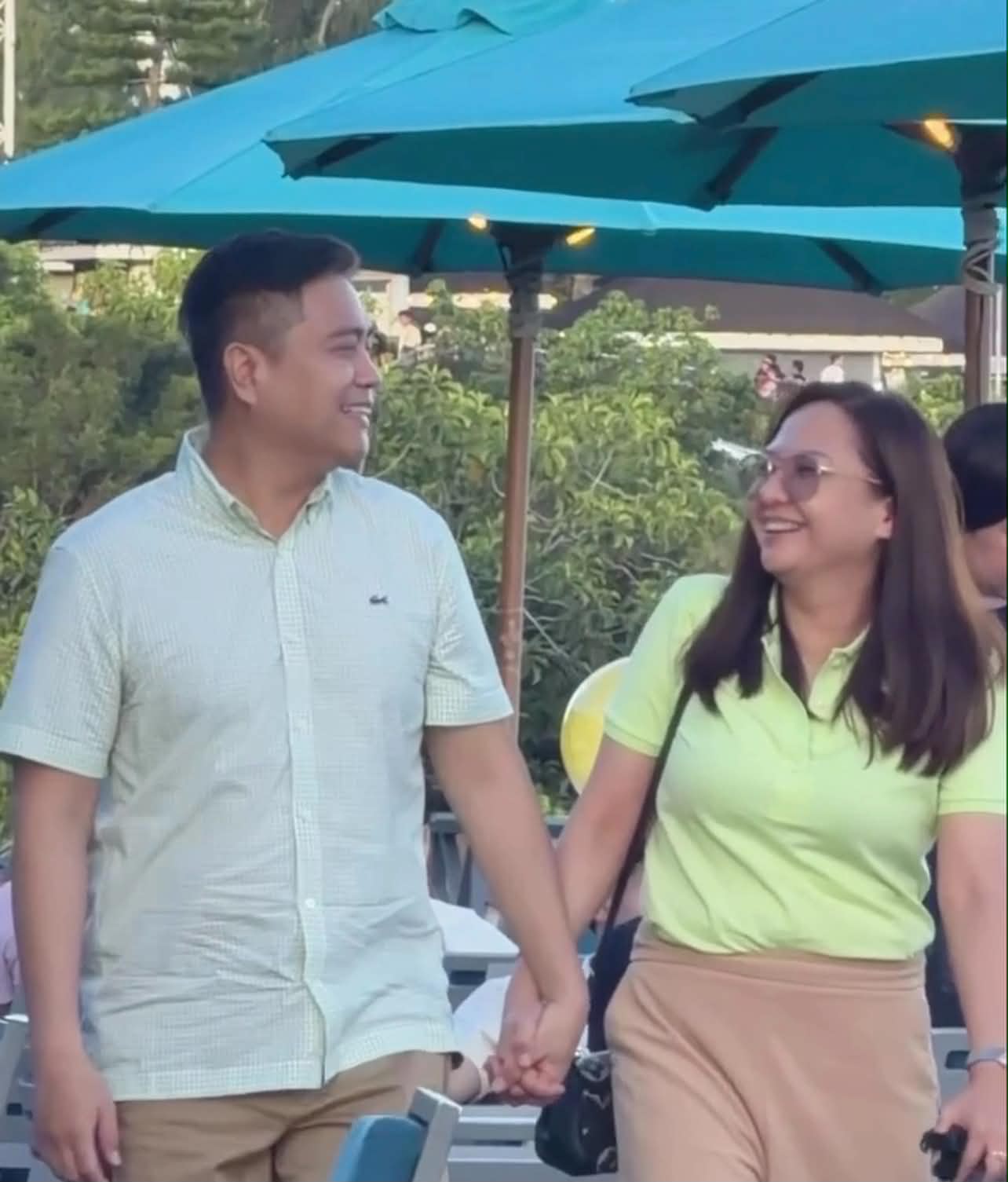 Arvin and Berna walking hand in hand